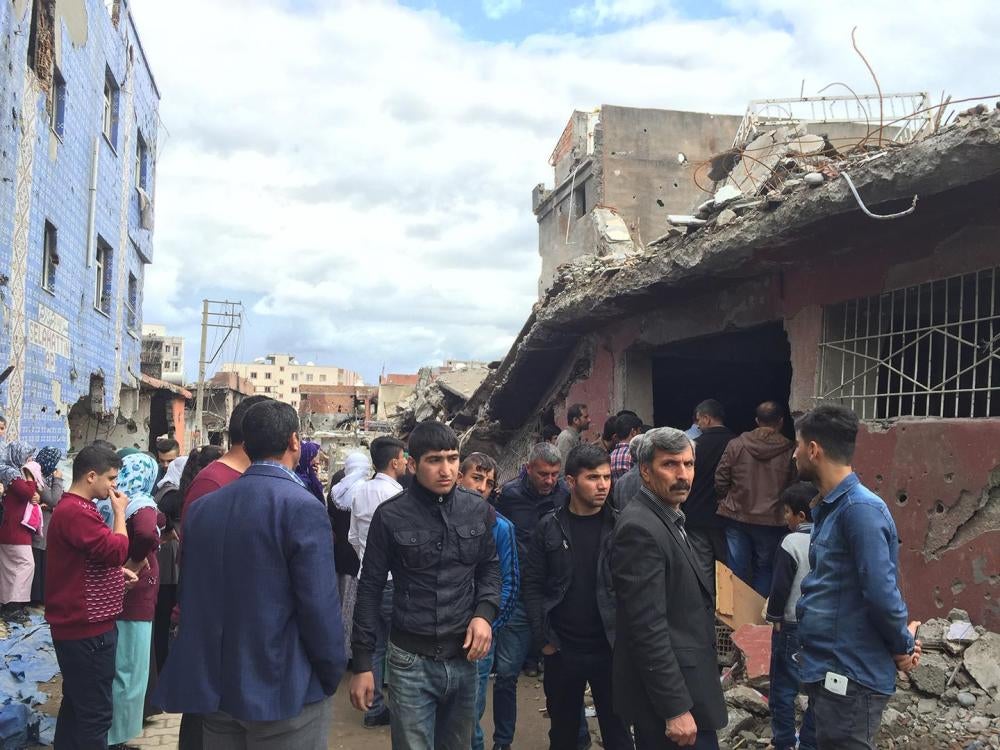 Cizre residents gather in front of a basement where 26 people died after it was stormed by the security forces. 