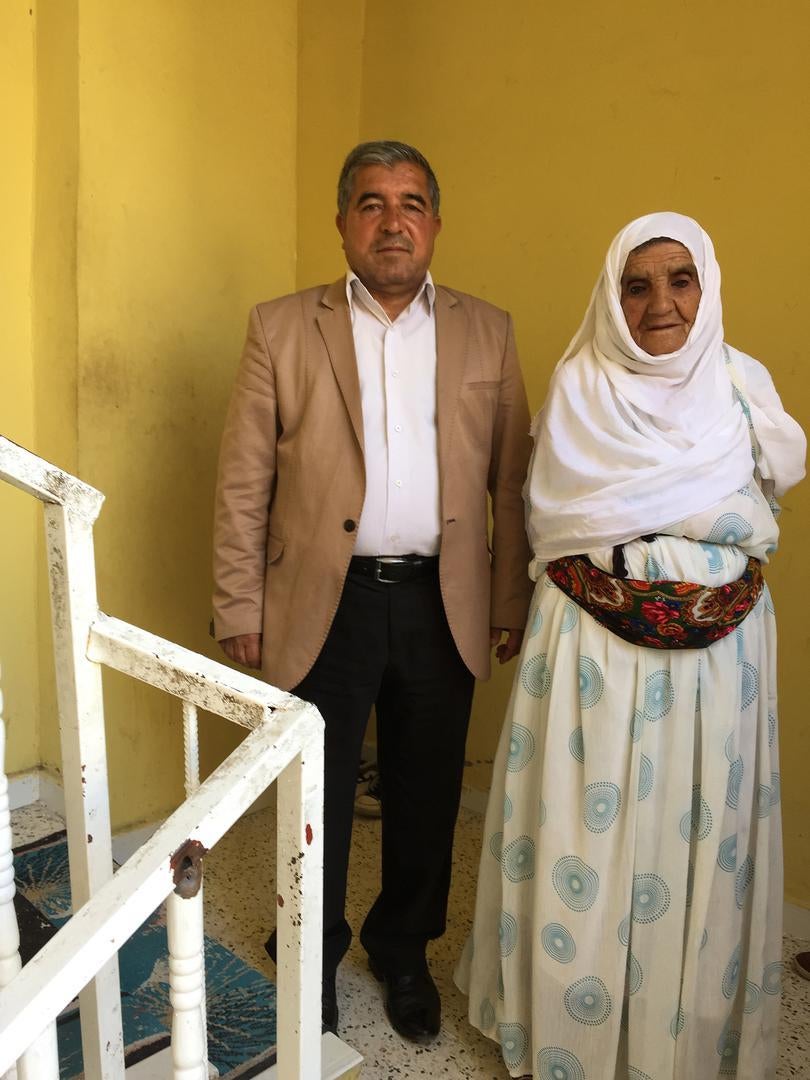 Abdurrahman İnce, the great uncle of Miray İnce, 3 months, and his mother, stand on the stairs in the house where Miray was fatally hit by a bullet as her aunt carried her downstairs. 