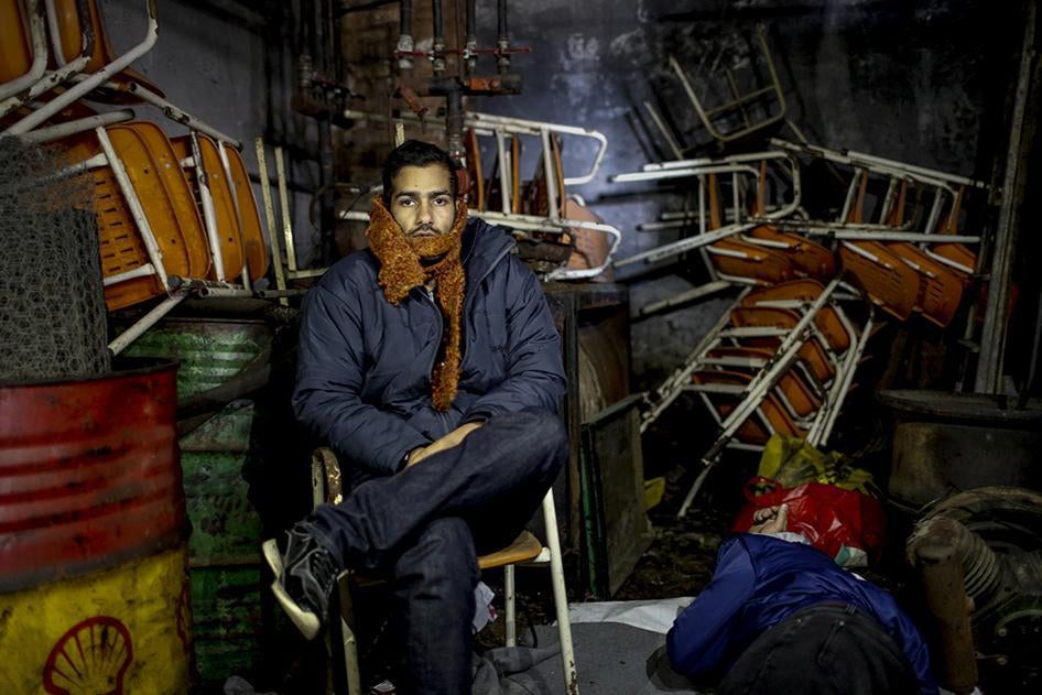 An Iranian migrant inside the garage he shares with dozens of others to sleep in freezing conditions near the Idomeni border crossing between Greece and Macedonia. January 25, 2016.