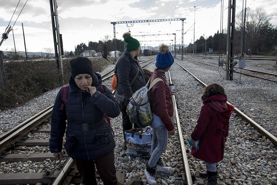 An Iranian family walk along the railway tracks at the Greek-Macedonian border at Idomeni. The family had paid smugglers in Athens $4,500 to be smuggled to onwards to northern Europe, only to find themselves abandoned at the border.  January 26, 2016.