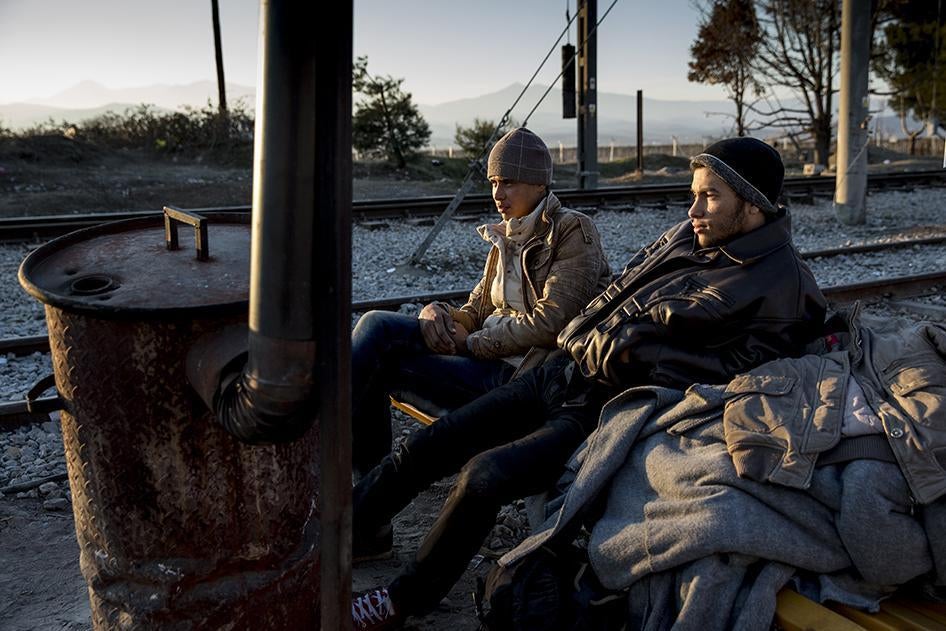 Migrants from North Africa try to warm themselves at the Idomeni border crossing between Greece and Macedonia.  January 28, 2016