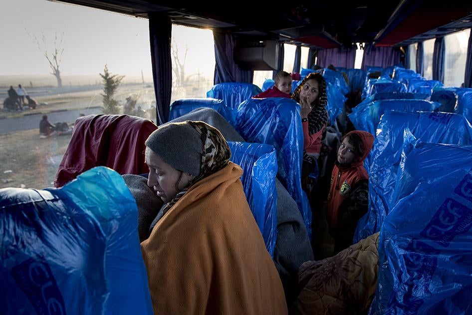 Women and children, mostly from Afghanistan, Syria, and Iraq, seek shelter on an unheated bus at a petrol station near the Greek border with Macedonia.  January 29, 2016.