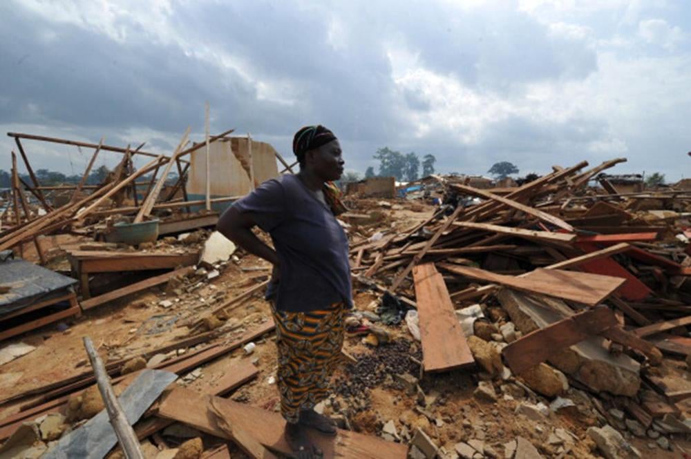 A woman looks at the ruins of the village of Baleko-Niégré, Côte d'Ivoire, razed during an eviction operation in the protected forest of Niégré in June 2013. More than 20,000 farmers were evicted during the operation.