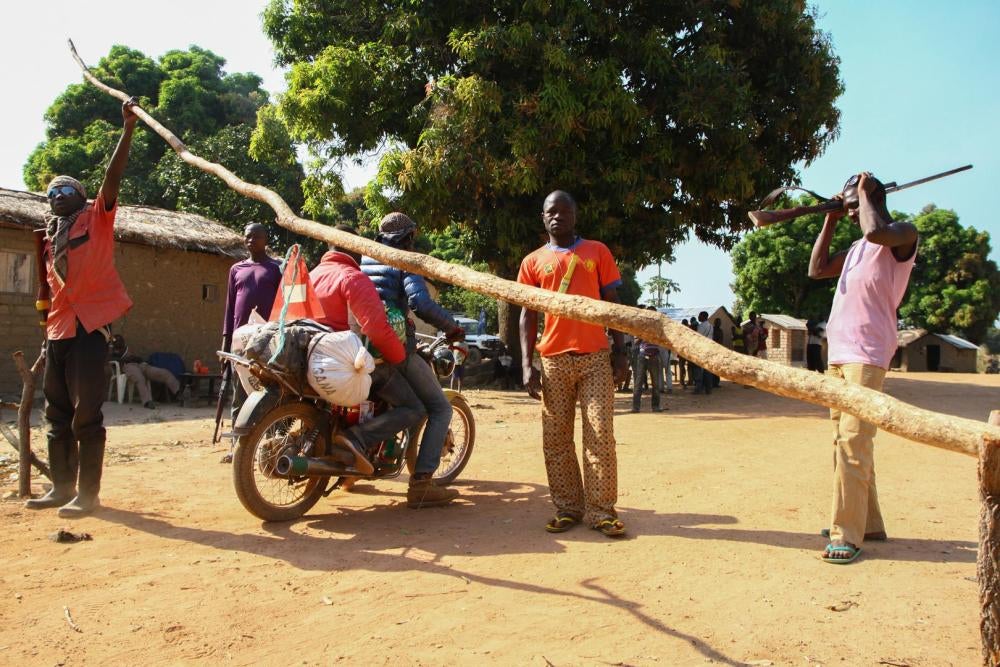 Anti-balaka fighters man a road block at Makonzi Wali, 20 kilometers south of Bocaranga and 20 kilometers east of De Gaulle, in the Koui sub-prefecture of the Ouham Pendé province, Central African Republic, on November 26, 2016. 