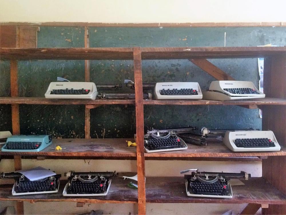 Broken braille machines, formerly used by students who are blind, sit on a shelf at a secondary school’s resource center for students with disabilities in Shinyanga, a city in northern Tanzania. 