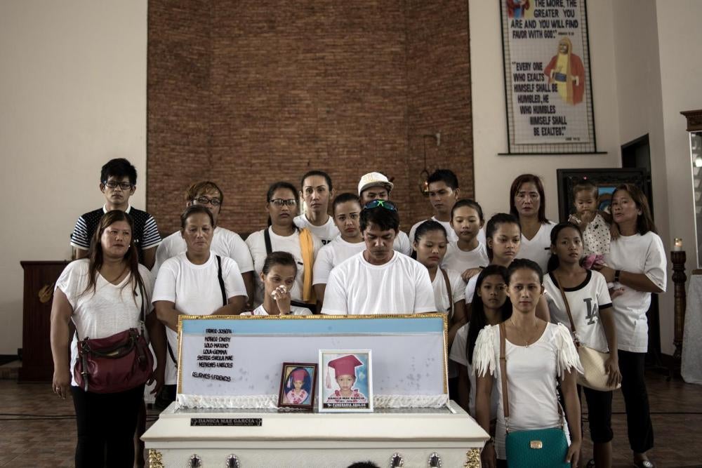 A family picture with the coffin of 5-year old Danica Mae Garcia after a pre-burial mass. An unidentified gunman targeting Garcia’s grandfather, Maximo Garcia, killed her while the family sat down to lunch at their home in Dagupan City, Pangasinan. 