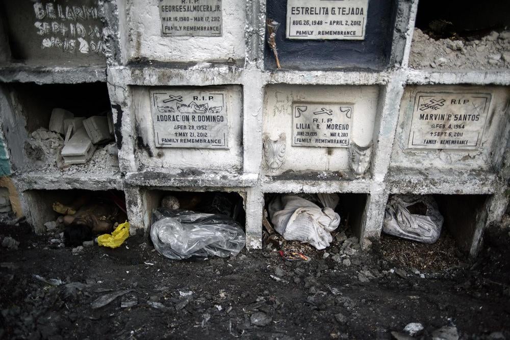 Bodies of unclaimed drug campaign victims lie beneath graves at a Manila cemetery, January 24, 2017.