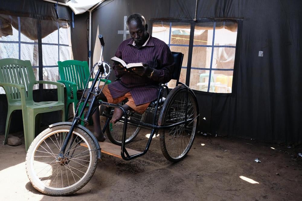 John Biel Dup, a former civil servant from Nassir, reads a book in the Juba Protection of Civilians 3. 
