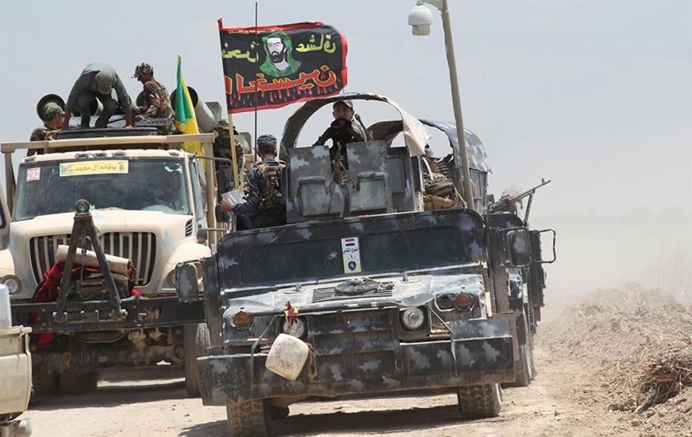 Iraqi security forces and Shi'ite fighters in military vehicles near Falluja, May 31, 2016.  