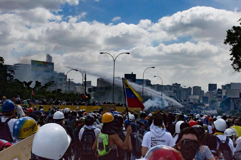 Venezuelan security forces use a water cannon to disperse an anti-government demonstration on the Francisco Fajardo Highway.