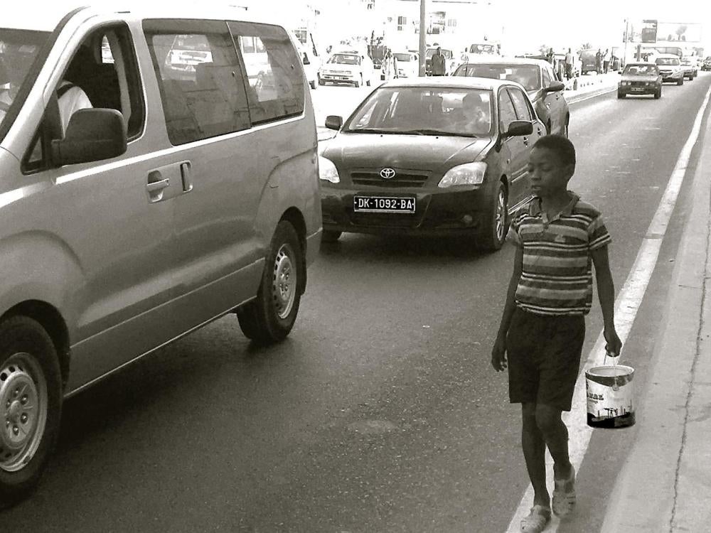 A talibé begs for money in downtown Dakar traffic in Senegal, May 5, 2017. 