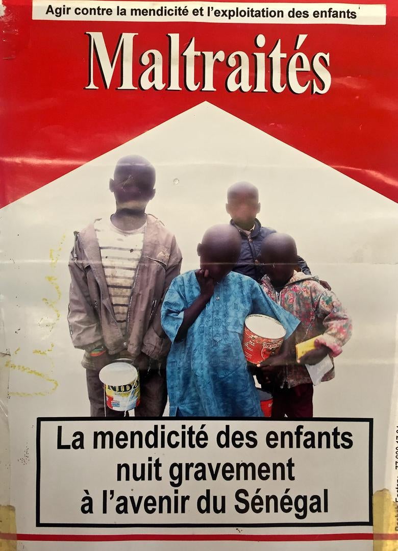 A poster in Dakar, Senegal that reads, in French: “Abused: child begging severely undermines Senegal’s future. Act against child begging and exploitation.” Photo taken May 2, 2017. 