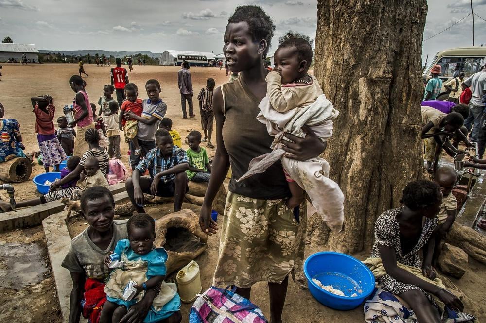South Sudanese gather at the Goboro transit camp on the South Sudan-Uganda border, before moving on to refugee settlements further inside Uganda, April 11, 2017.