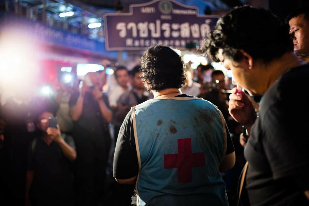 On August 30, 2017, Phayao Akhard wears the bloody nurses gown worn by her daughter, nurse Kamolkate “Kate” Akhard, when she was killed by Thai Special Forces soldiers while tending wounded persons at the front of Wat Pathum temple on May 19, 2010, to pro