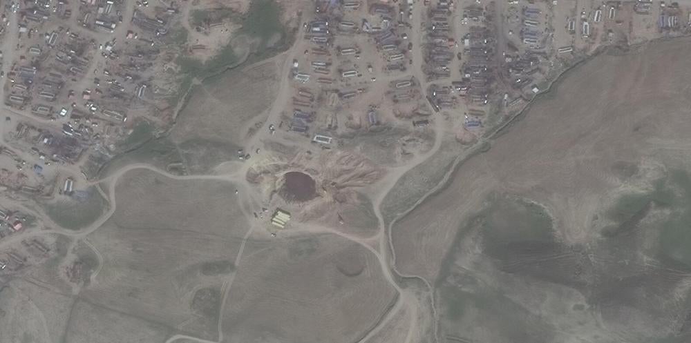 Satellite imagery showing the Khafsa sinkhole being filled in by June 2015 © 2017 DigitalGlobe
