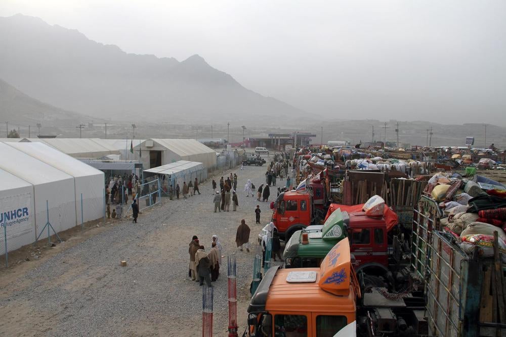 Trucks hired by Afghan refugees forced out of Pakistan and packed with their belongings line up at the UN refugee agency’s support center outside Kabul, October 2016.  