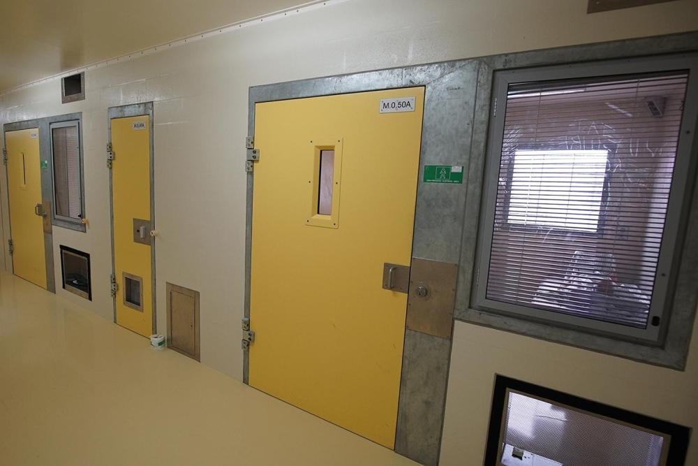 A prisoner lies in his solitary confinement cell in the safety unit at Lotus Glen Correctional Centre, northern Queensland.  