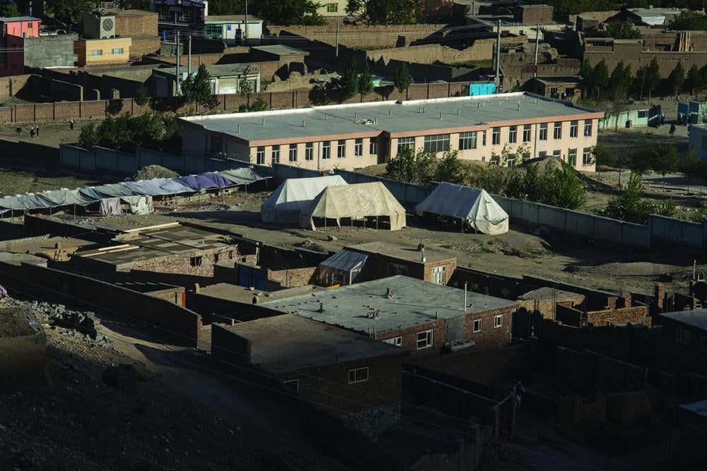 At this Kabul government school, the tents in the vacant lot are a girls' school where over 600 girls study.