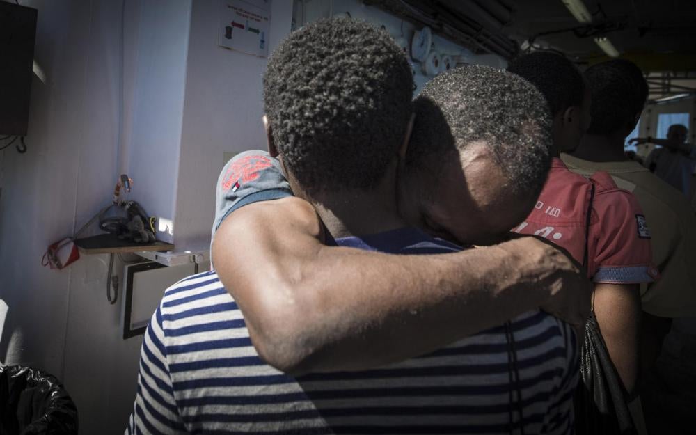 Two men hug following their rescue by SOS MEDITERRANEE. October 10, 2017.