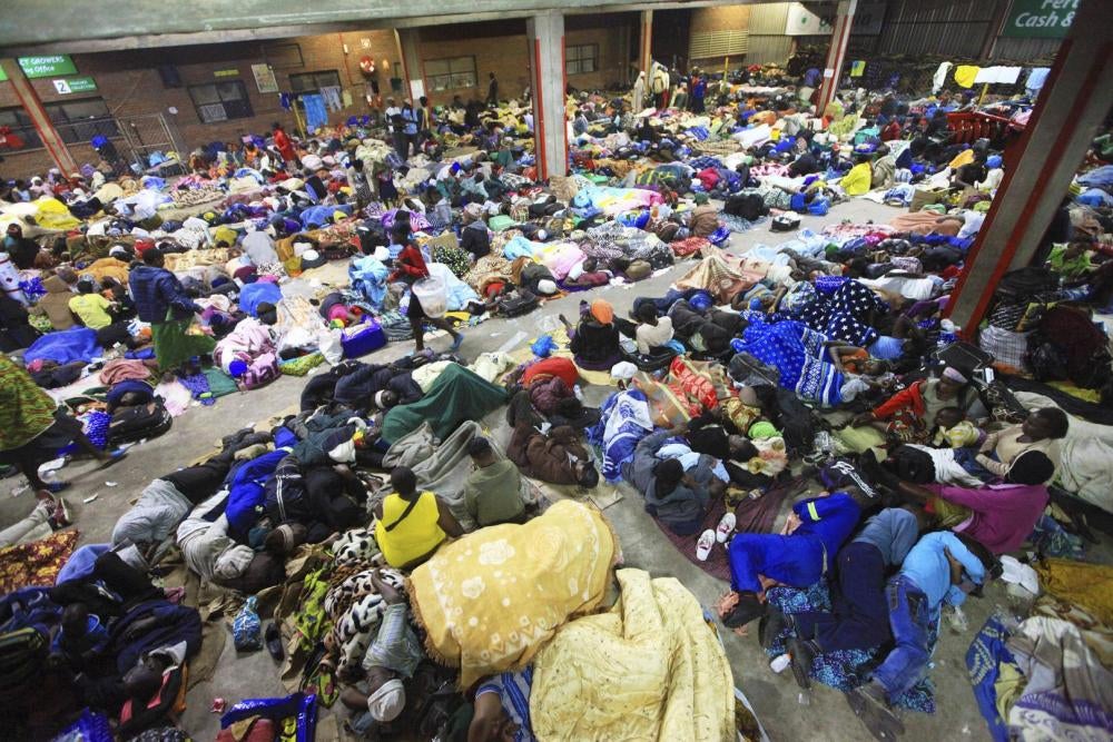 Tobacco farmers sleep in an auction house in Harare, Zimbabwe waiting to sell their tobacco crop to buyers.