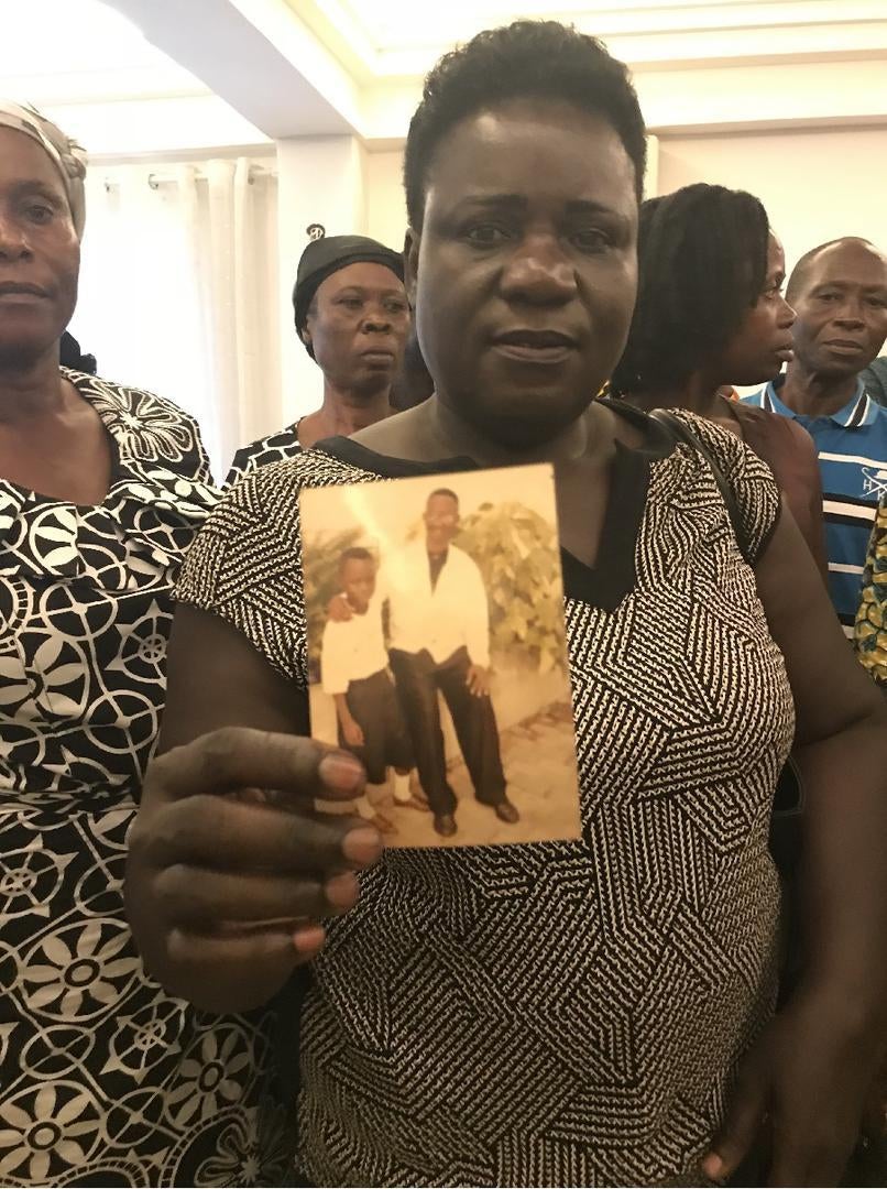 Constance Otoriwah holds a photo of her son Enoch Amoh, missing in Gambia. Kumasi Ghana, April 2018.