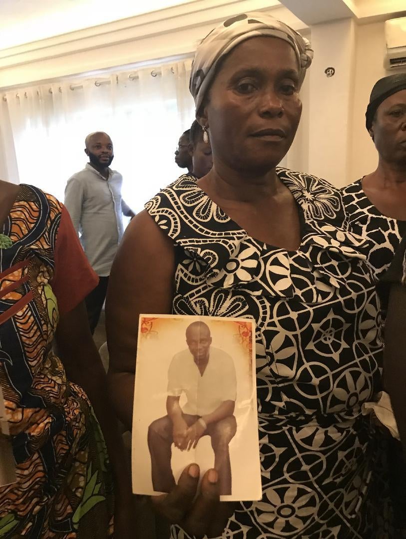 Joyce Opoku holds a photo of her son Kojo Antwi, killed in Gambia. Kumasi, Ghana, April 2018.