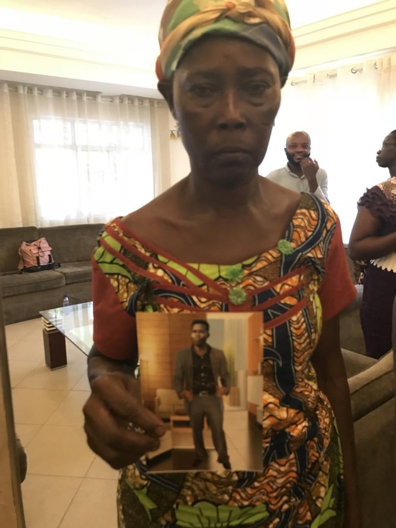 Rose Takyiwaa holds a photo of her son Kwabena Kusi Mose killed in Gambia. Kumasi, Ghana, April 2018.