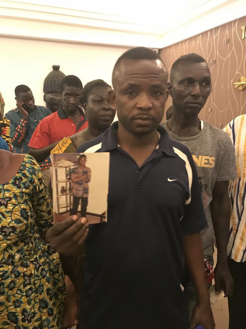 Siaka Amadou  holds a photo of his nephew Albari Kassim, missing in Gambia. Kumasi, Ghana, April 2018.