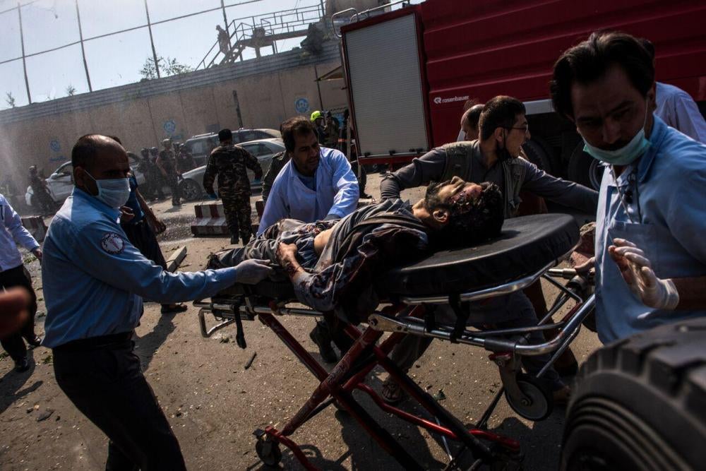 Medical workers transport an injured man on a stretcher to an ambulance near the site of a truck bomb in Kabul, May 31, 2017. 