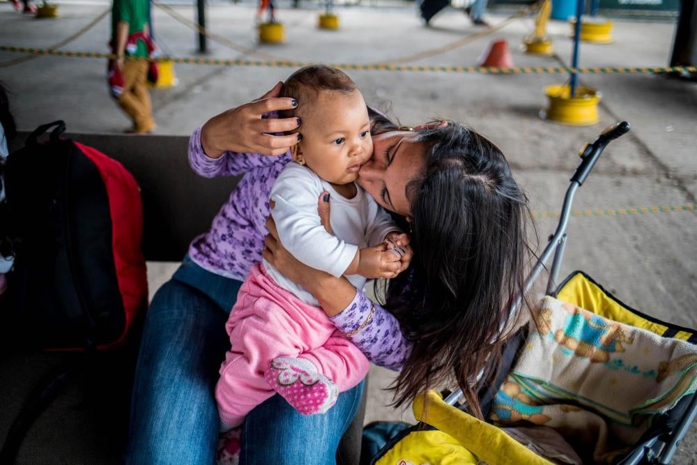 A Venezuelan mother waits to have her daughter vaccinated at the Colombian border because vaccines are not readily available in Venezuela on July 28, 2018.