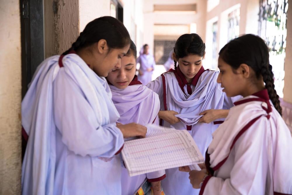 Des élèves consultent le cahier d’appel au lycée public de filles de Behar Colony, situé dans le quartier de Lyari à Karachi (Pakistan). 