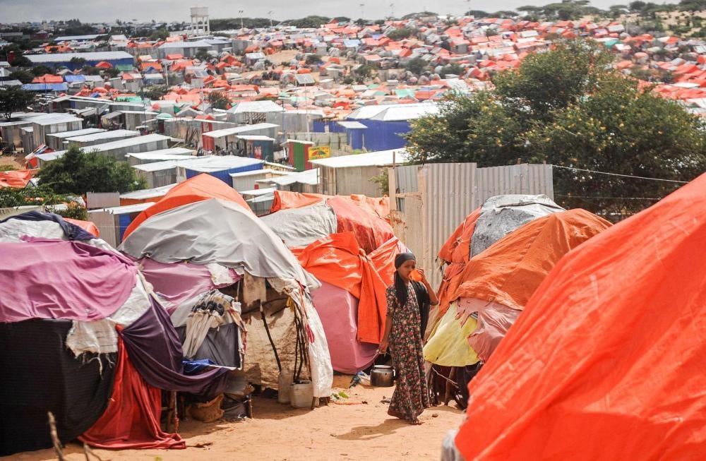 A Somali girl stands next to her makeshift tent at Tawakal internally displaced persons camp in Mogadishu, Somalia, June 19, 2018. The number of internally displaced people, many living unassisted and at risk of serious abuse, reached an estimated 2.7 mil