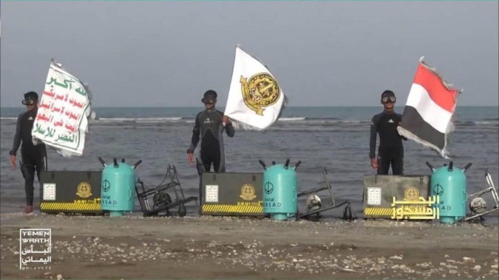 Houthi military forces stand beside Yemeni-produced “Mersad” naval mines. © 2018