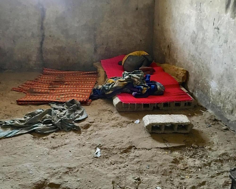 A talibé child sleeps on top of an improvised bed made of bricks at a daara in the city of Diourbel, Senegal, June 24, 2018. At night, talibé children slept on mats on the sand, many without mosquito nets to protect them from malaria.