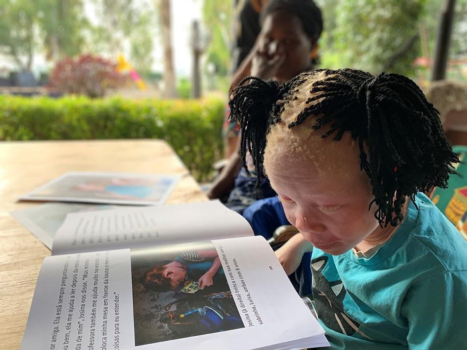 Josina, featured in Human Rights Watch's report "From Cradle to Grave," reads the accessible version of the report in Mozambique.