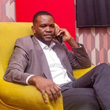 Stanis Bujakera sits and faces camera. 