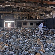 One individual walks through rubble. 