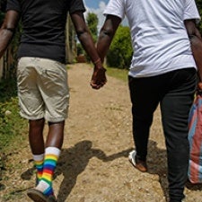 Two individuals hold hands. 