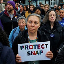 Protesters hold sign reading "Protect SNAP".