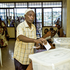 Individual places ballot in ballot box. 