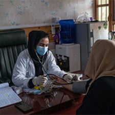 Women sit together in Afghanistan. 