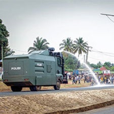 Truck sprays water at protesters. 