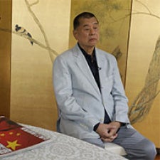 Jimmy Lai faces camera. 