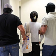 One person detained by two plain-clothes officers.