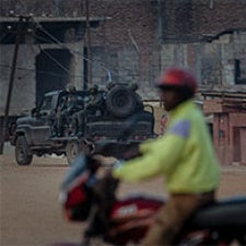 Figure rides motor bike. 