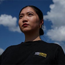 Anna Kwok faces camera. 