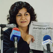 Yanar Mohammed holds camera at press conference. 