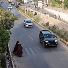 Woman crossing street at crosswalk 