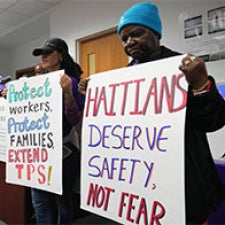 People standing holding signs 