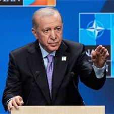 Turkish President Recep Tayyip Erdogan standing at podium delivering a speech 